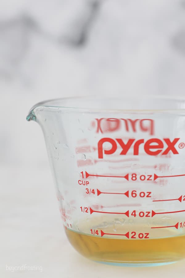 a glass measuring bowl with reduced champagne
