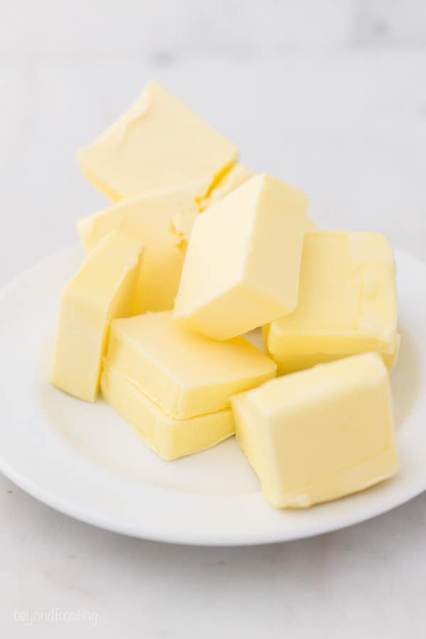 a white plate with chunks of cut up butter