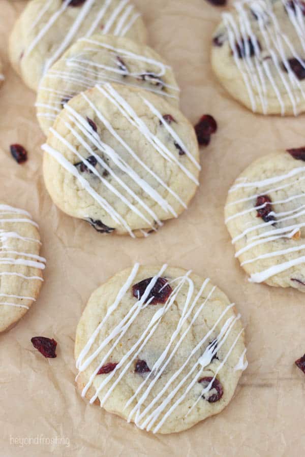 overhead shot of cranberry orange cookies on brown parchment paper