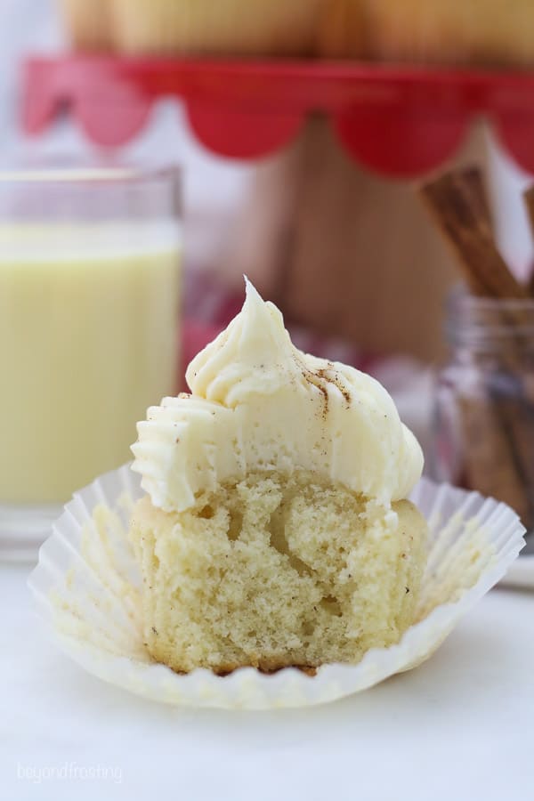 an eggnog cupcake with a bite taken out it