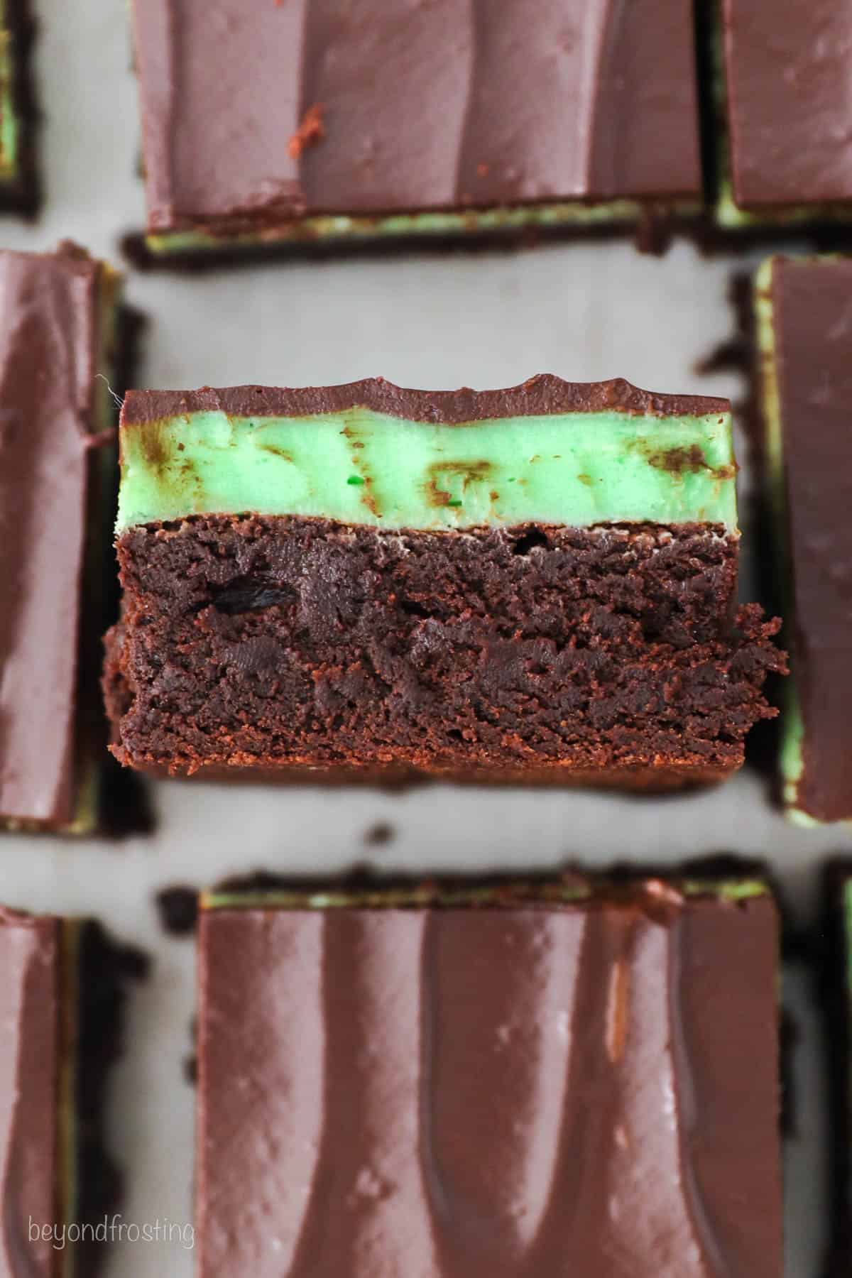 Overhead view of a mint chocolate brownie turned on its side to reveal the mint chocolate layers.