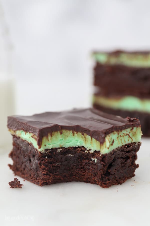 A brownie with mint frosting and a bite taken out of it