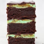 Three mint chocolate brownies stacked on top of one another.