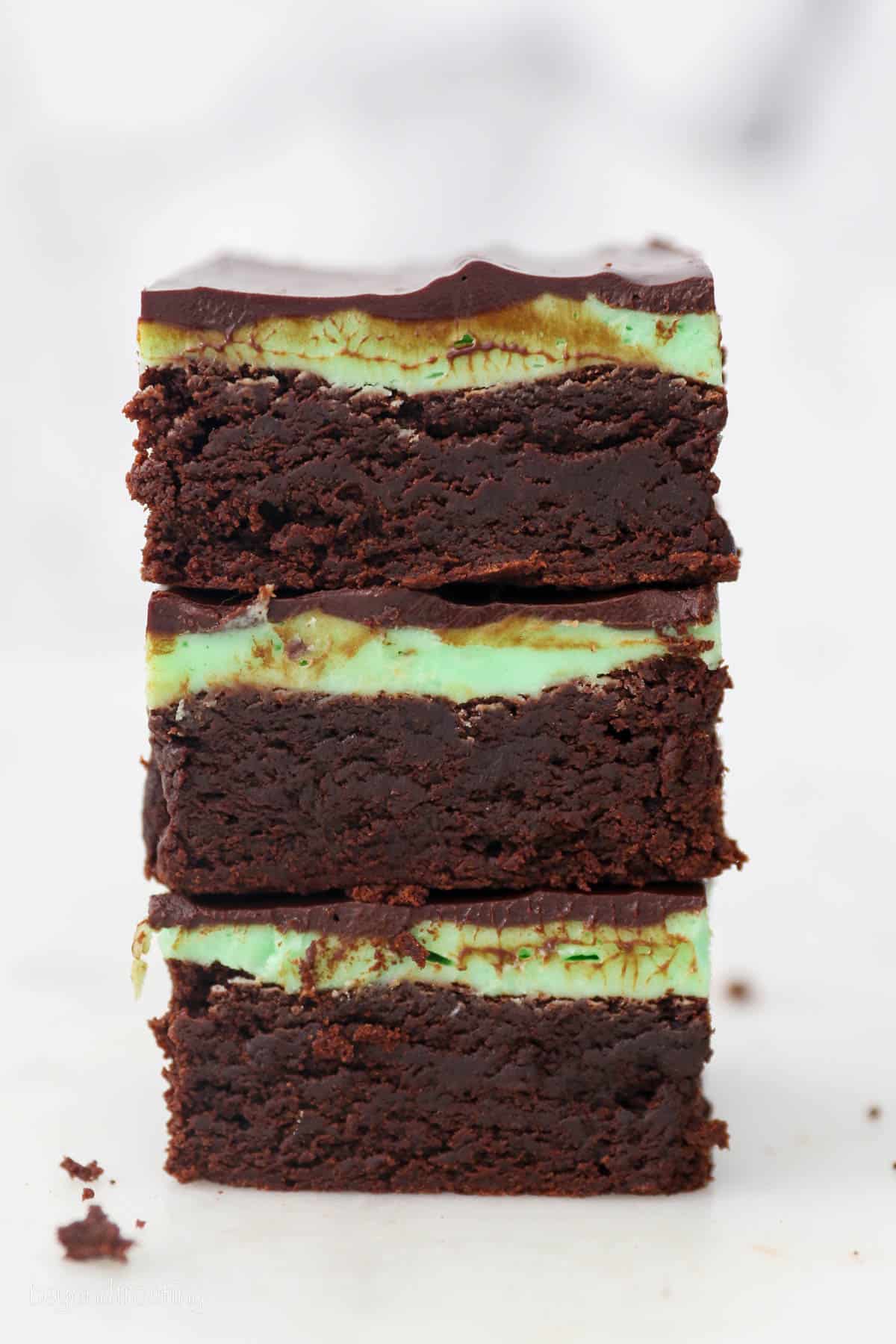 Three mint chocolate brownies stacked on top of one another.