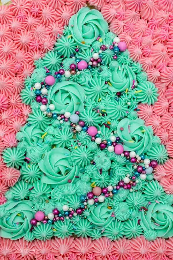 a close up image of a Christmas tree decorated with buttercream