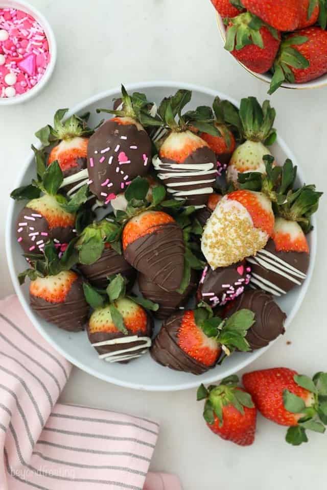 A Bowl full of White and Dark Chocolate Covered Strawberries with Valentine's Sprinkles