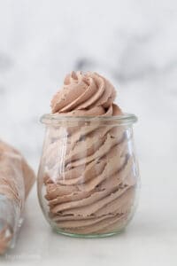 A glass jar filled with chocolate whipped cream