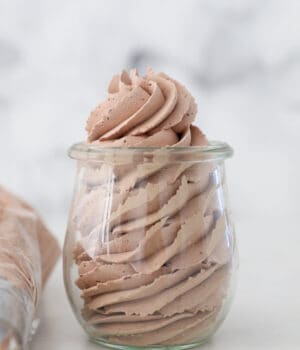 A glass jar filled with chocolate whipped cream