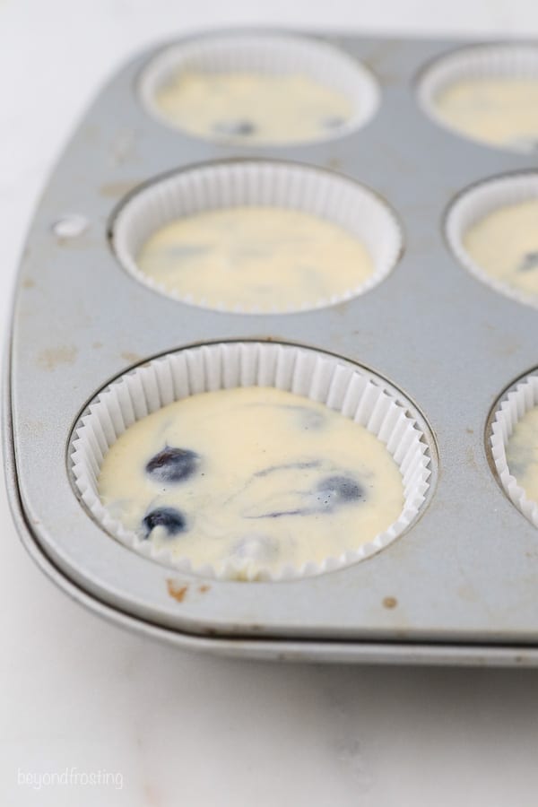 a close up of a muffin tin with batter in it