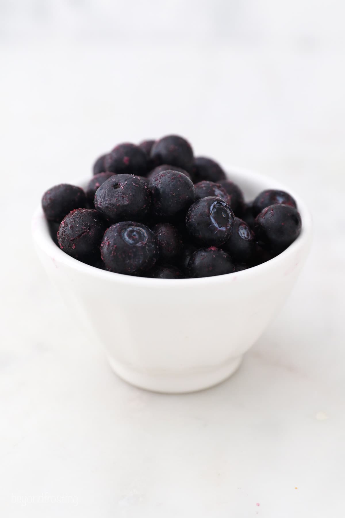 Blueberries in a white bowl.