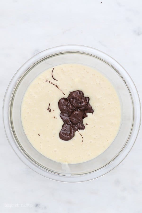 a top view of a mixing bowl of chocolate being mixed intocake batter