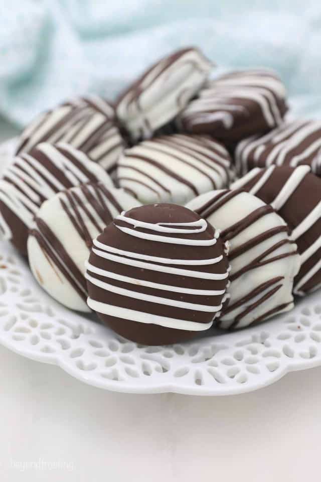 White and Milk Chocolate Covered Oreos on a Fancy White Plate
