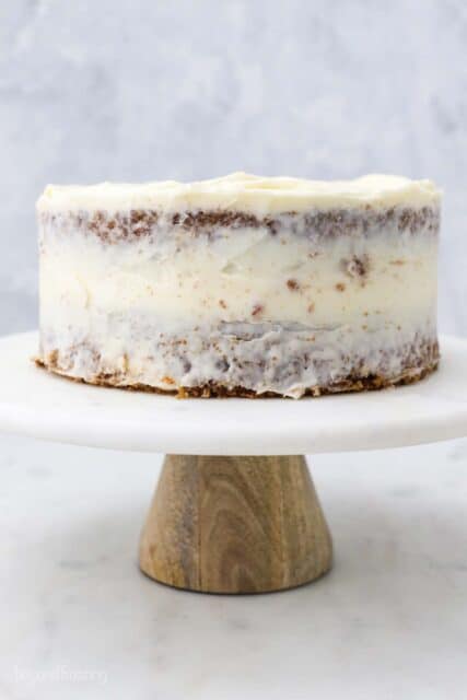 a marble cake plate with a crumb coated carrot cake
