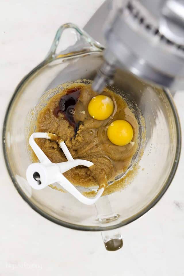 overhead shot of a mixing bowl of brown sugar, eggs and vanilla