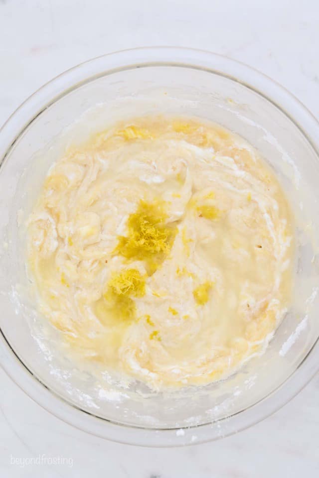 Overhead shot of glass mixing bowl in batter for a lemon bread