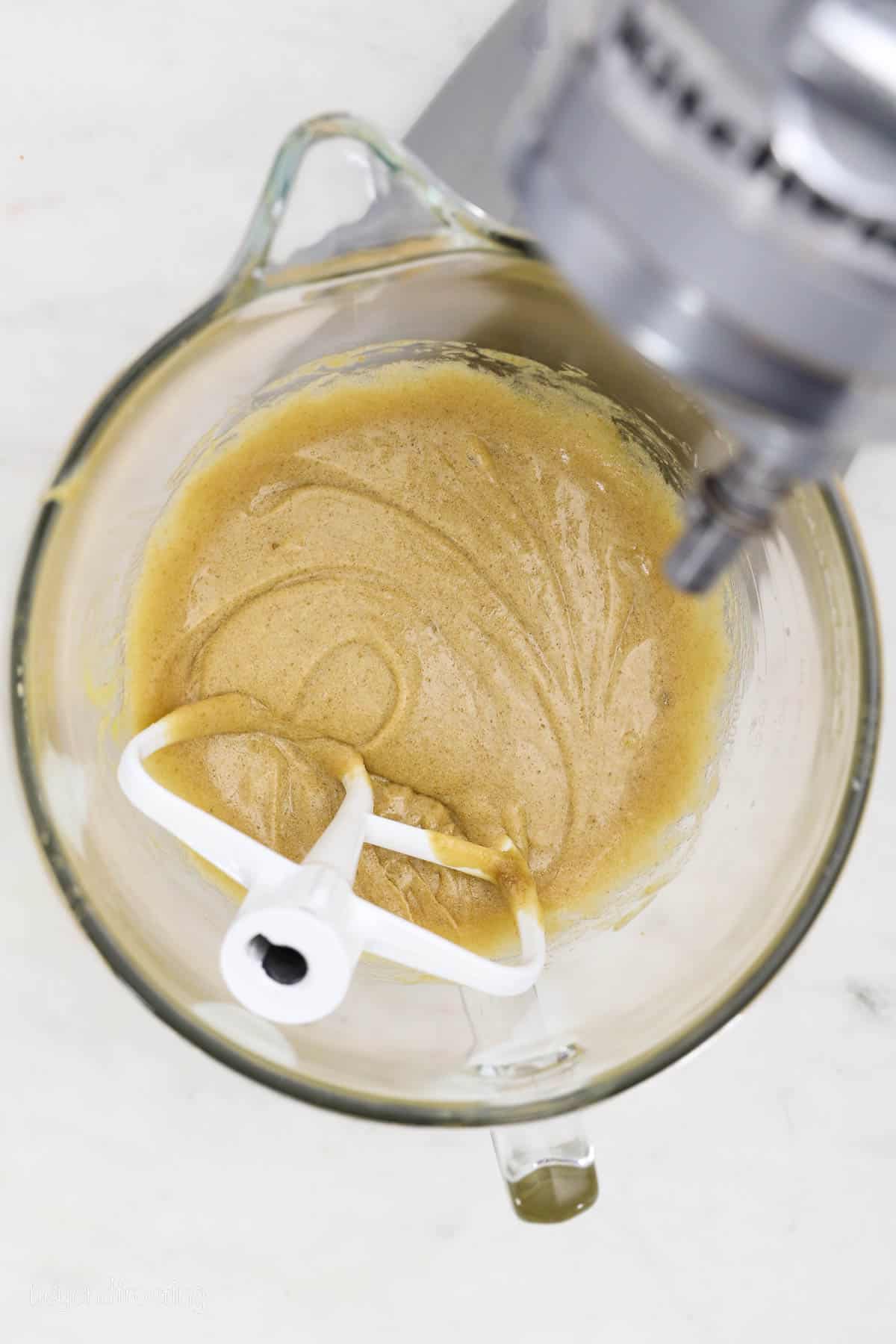 Blondie batter in a mixing bowl with a stand mixer attachment.