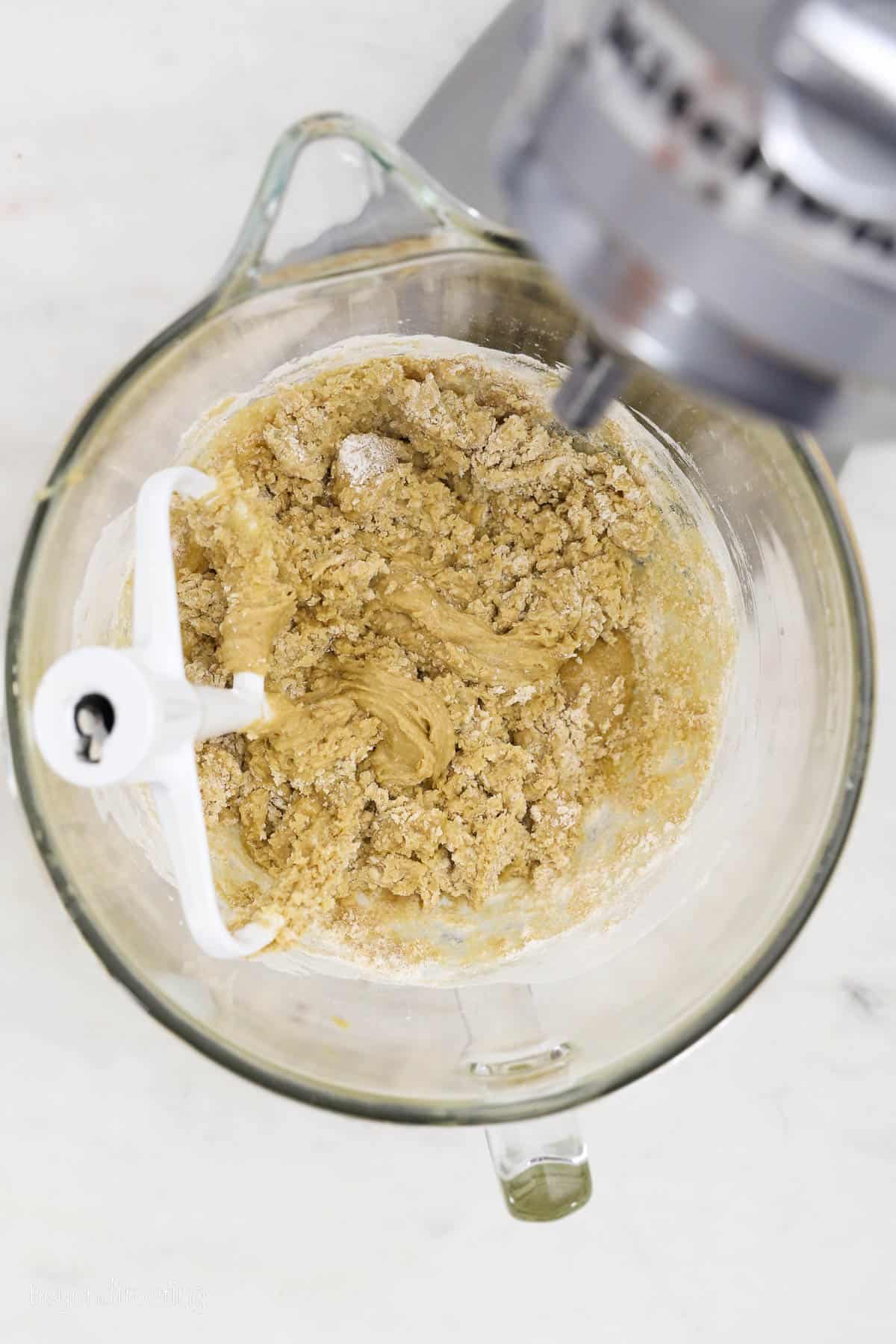 Blondie batter in a mixing bowl with a stand mixer attachment.