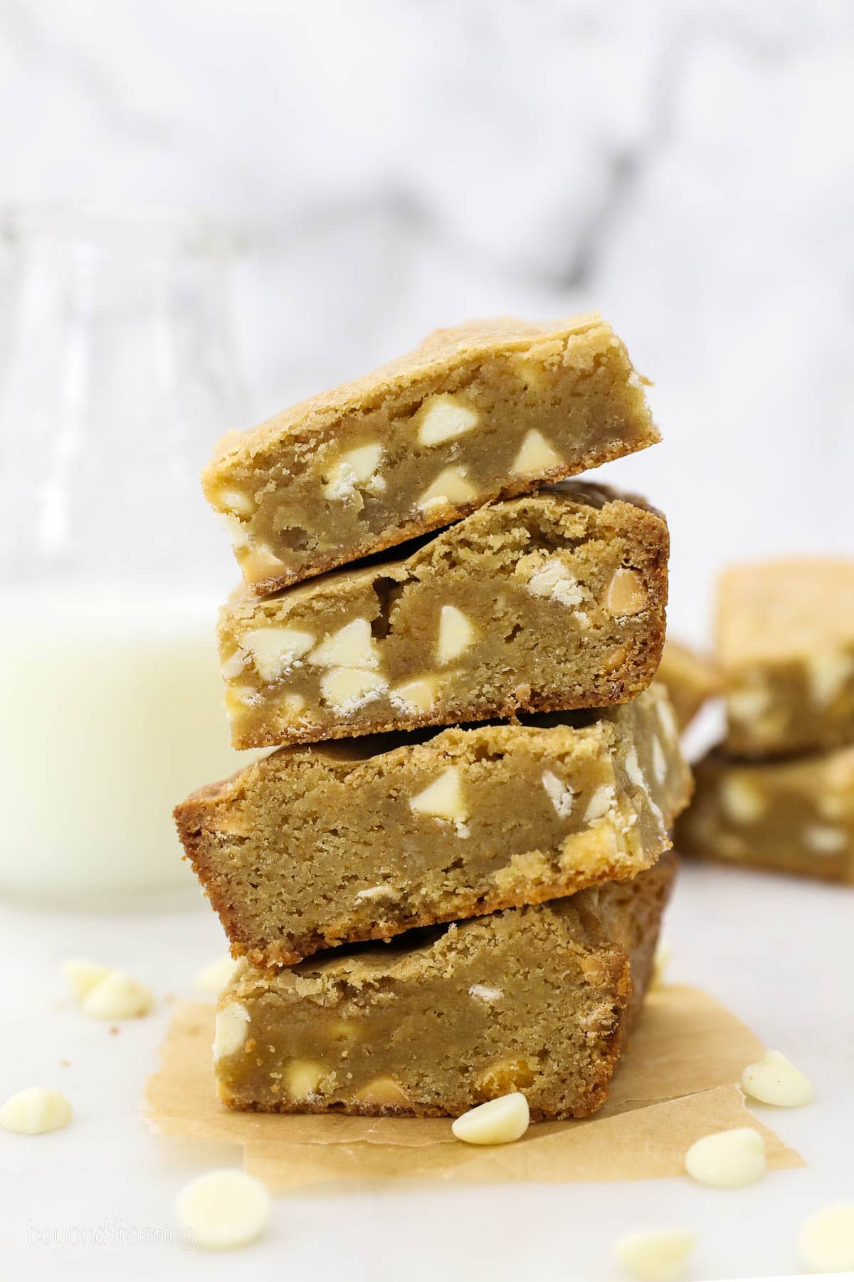 Four blondies stacked on top of one another on a countertop.