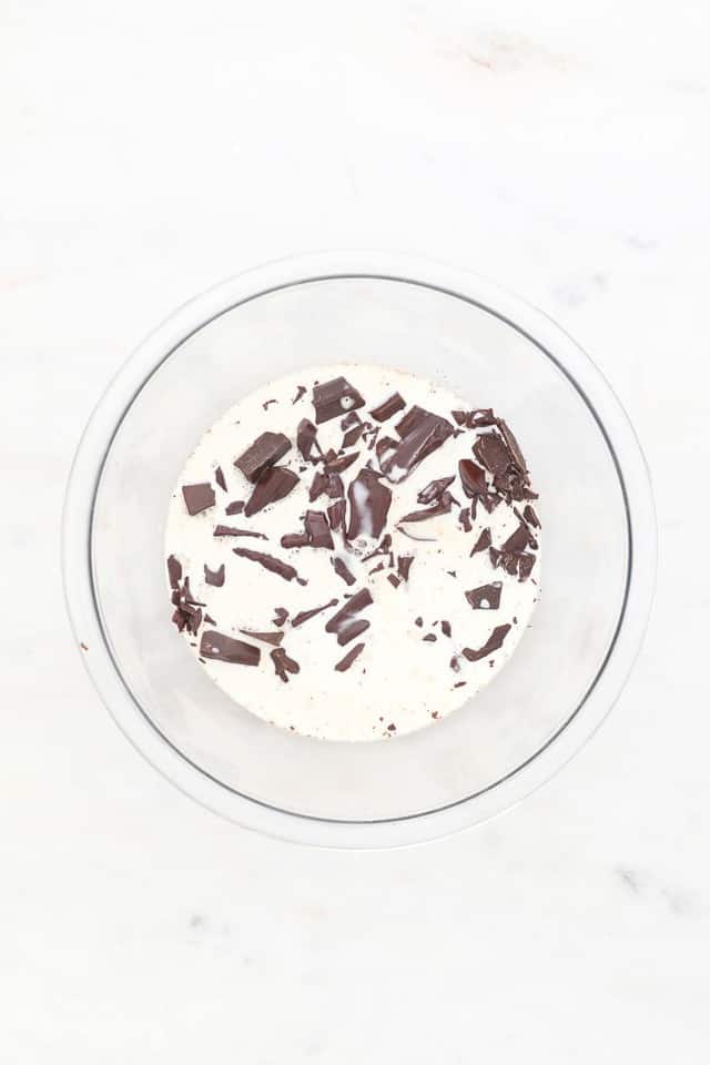 A Bowl of Chopped Chocolate and Hot Heavy Whipping Cream