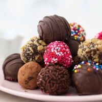 Chocolate Truffles Piled Onto a Light Pink Dessert Plate