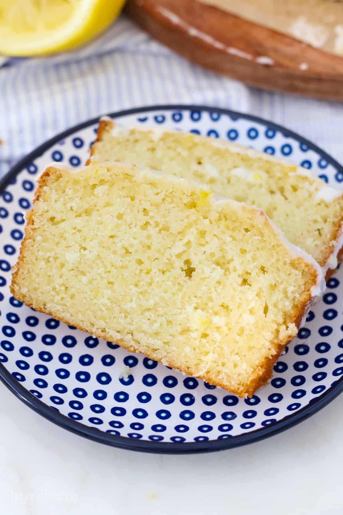Lemon bread slices on a blue dotted plate.