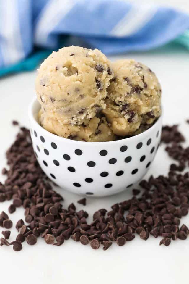 A Black and White Polka Dotted Bowl Holding Balls of Chocolate Chip Cookie Dough