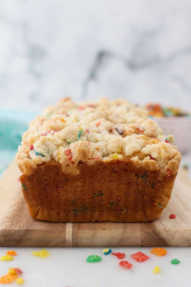 A loaf of Fruity Pebble Cake on a cutting board
