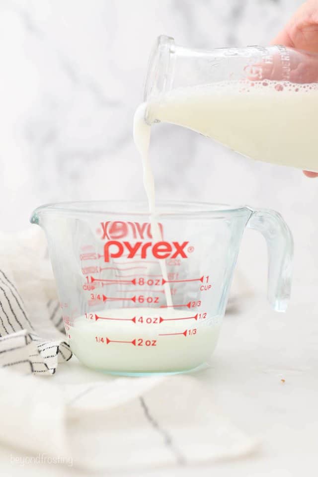 Milk Being Poured From a Glass to a Measuring Cup