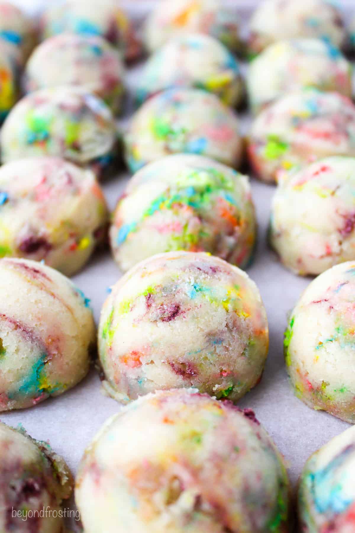 Rows of Lucky Charms cookie dough balls.