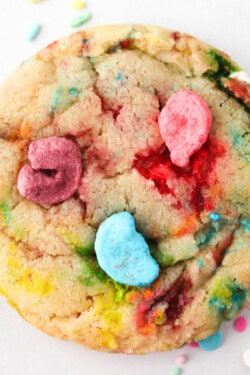 Close up view of a Lucky Charms cookie on a white surface.