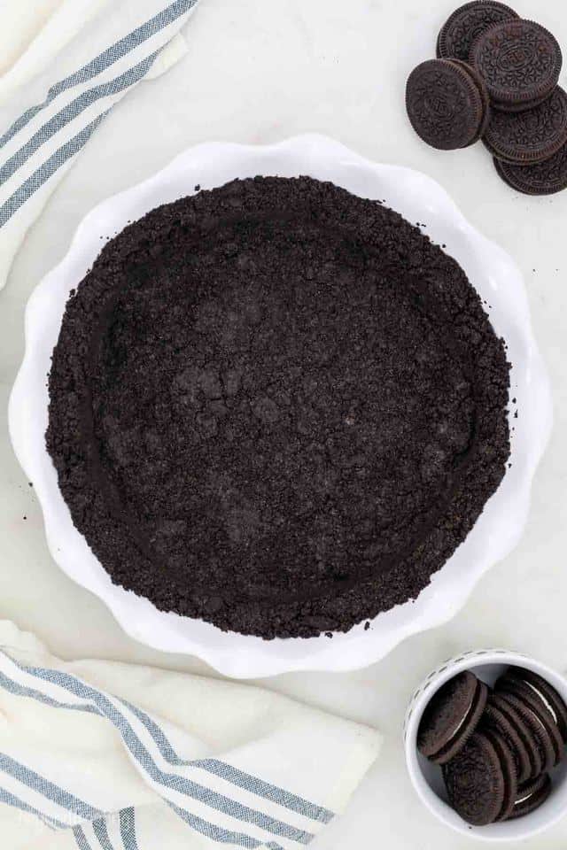 A Bird's Eye View of an Oreo Cookie Crust Pressed Into a Pie Plate