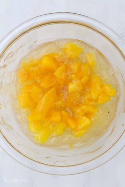 overhead view of glass bowl with chopped peaches