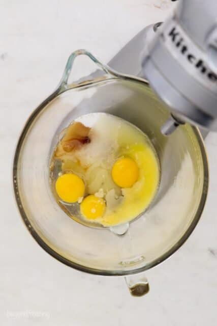 overhead of a stand mixer with eggs and other ingredients