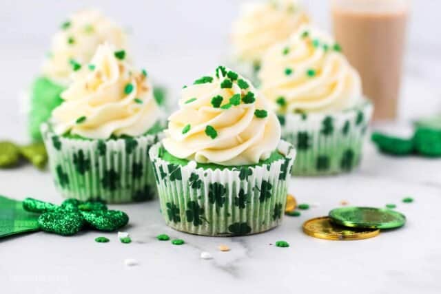five green cupcakes decorated for St Patricks day, green cupcake frosted and decorated with shamrock sprinkles
