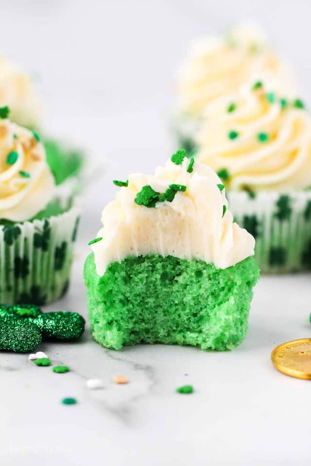 A green cupcake with a bite taken out of it
