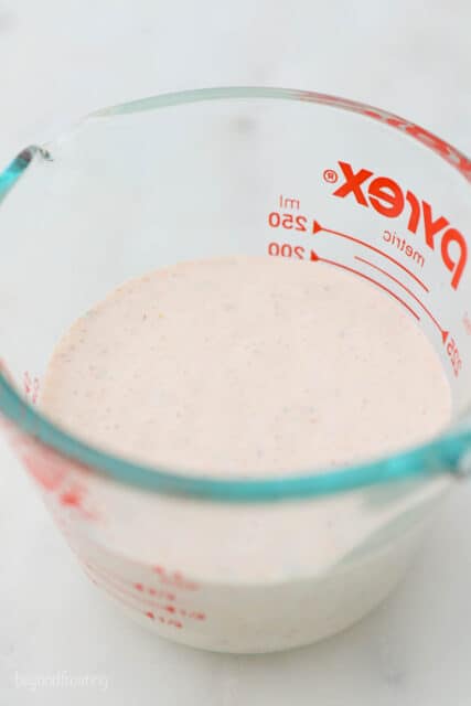 a glass measuring cup with heavy cream