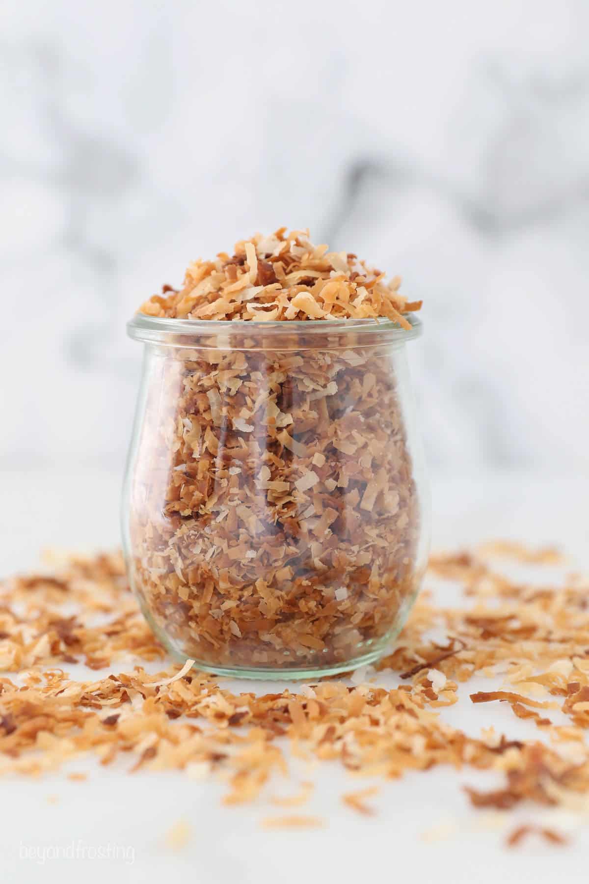 A glass jar of toasted coconut