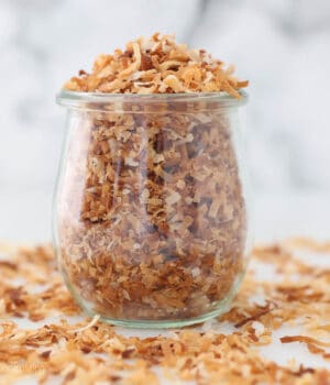 A glass jar of toasted coconut