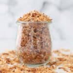 A jar filled with toasted coconut