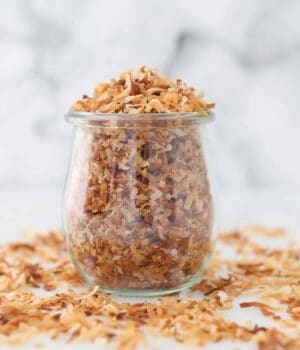 A jar filled with toasted coconut