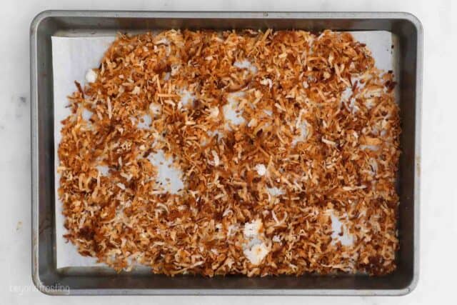 toasted coconut on a sheet pan lined with parchment paper
