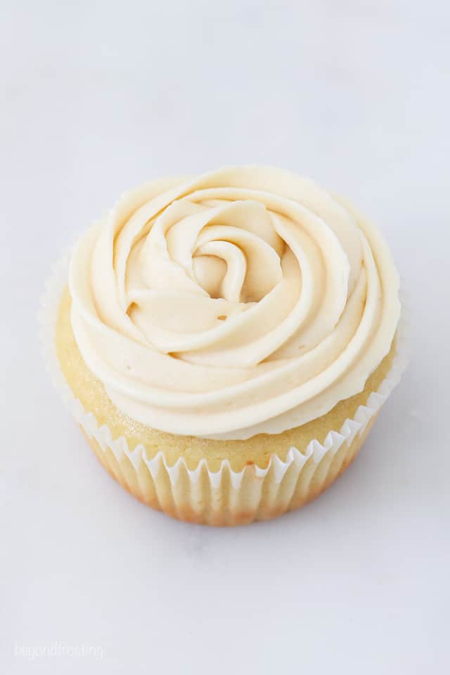 A vanilla cupcake frosted with a vanilla buttercream rose