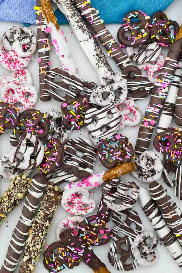 A mixture of chocolate covered pretzel rods and mini twists, in milk and white chocolate with a variety of sprinkles