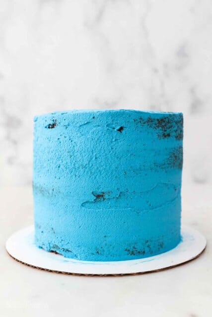 a chocolate cake with a blue colored crumb coating