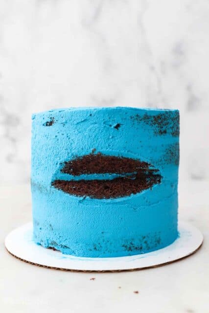an in-process shot of a cookie monster cake with the mouth cut out