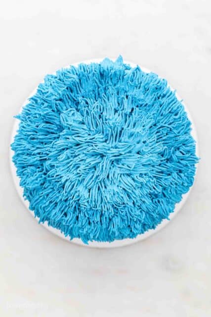 a frosted cookie monster cake showing the top of the cake