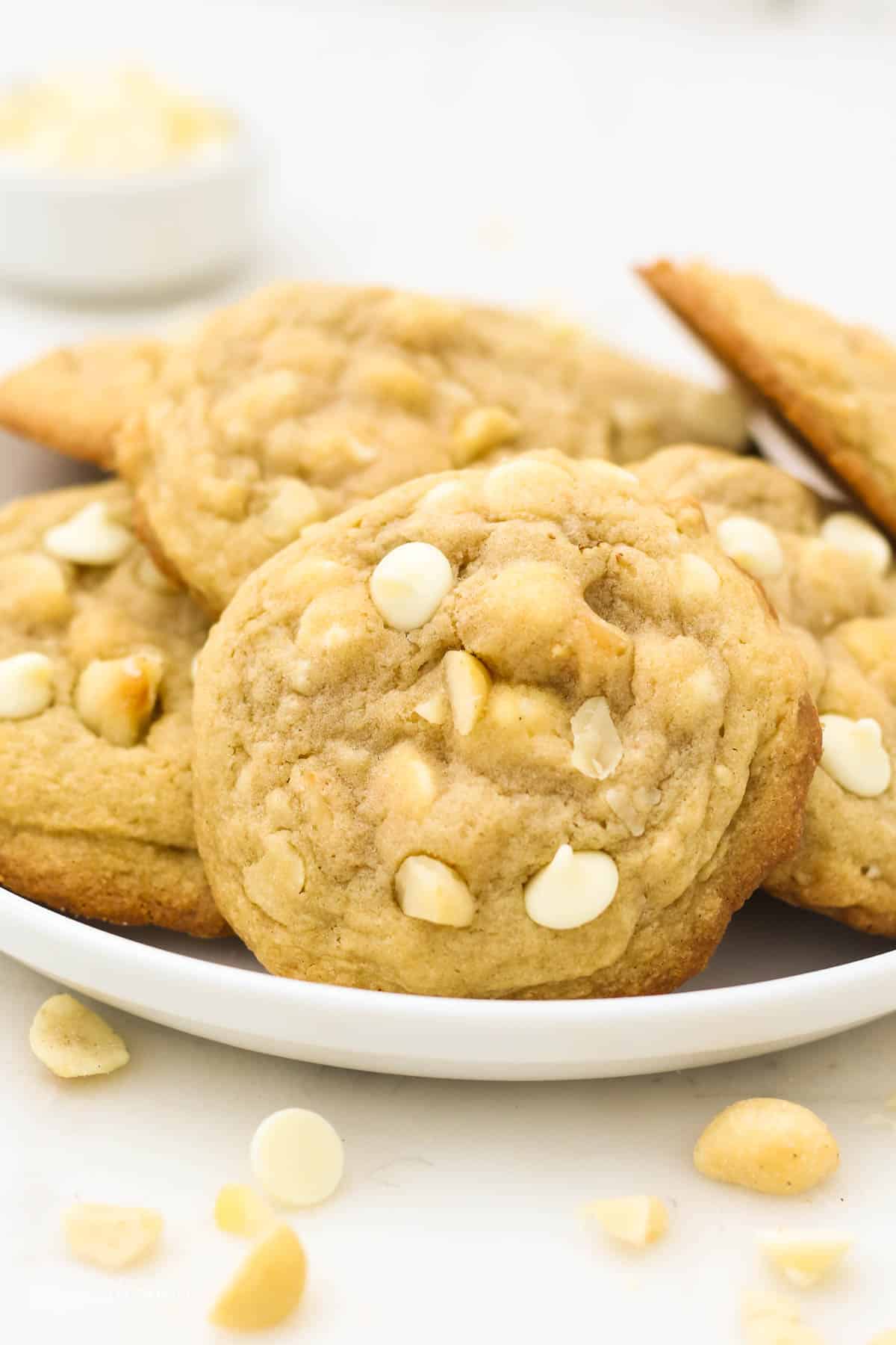 White Chocolate Macadamia Nut Cookies Piled Up on a White Plate
