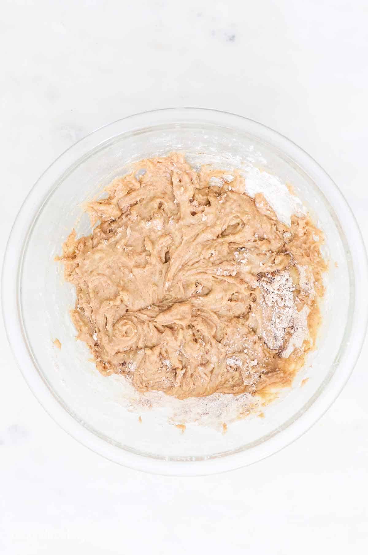 Zucchini bread batter in a glass bowl.