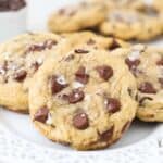 Gluten-free chocolate chip cookies topped with sea salt on a white plate