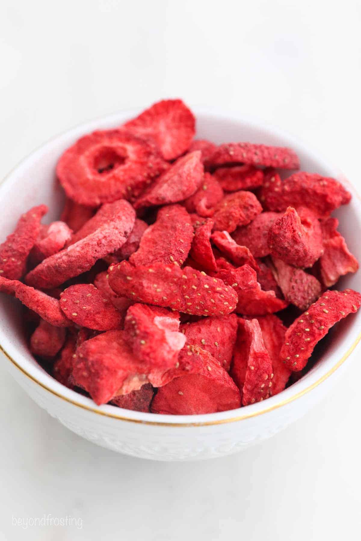 a small white bowl with freeze-dried strawberries